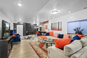 Living room featuring wood finished floors and recessed lighting