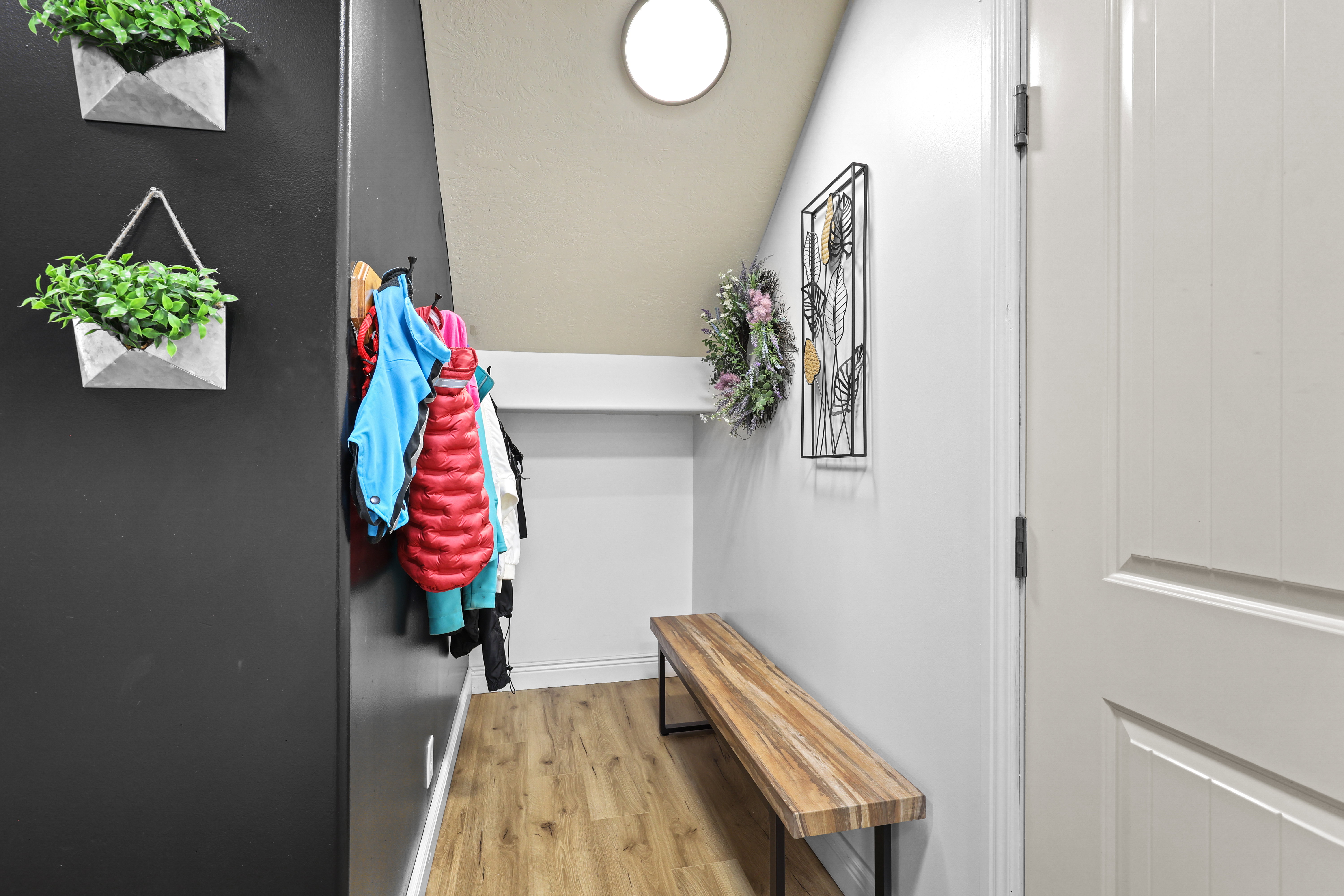 Doorway with wood finished floors and lofted ceiling