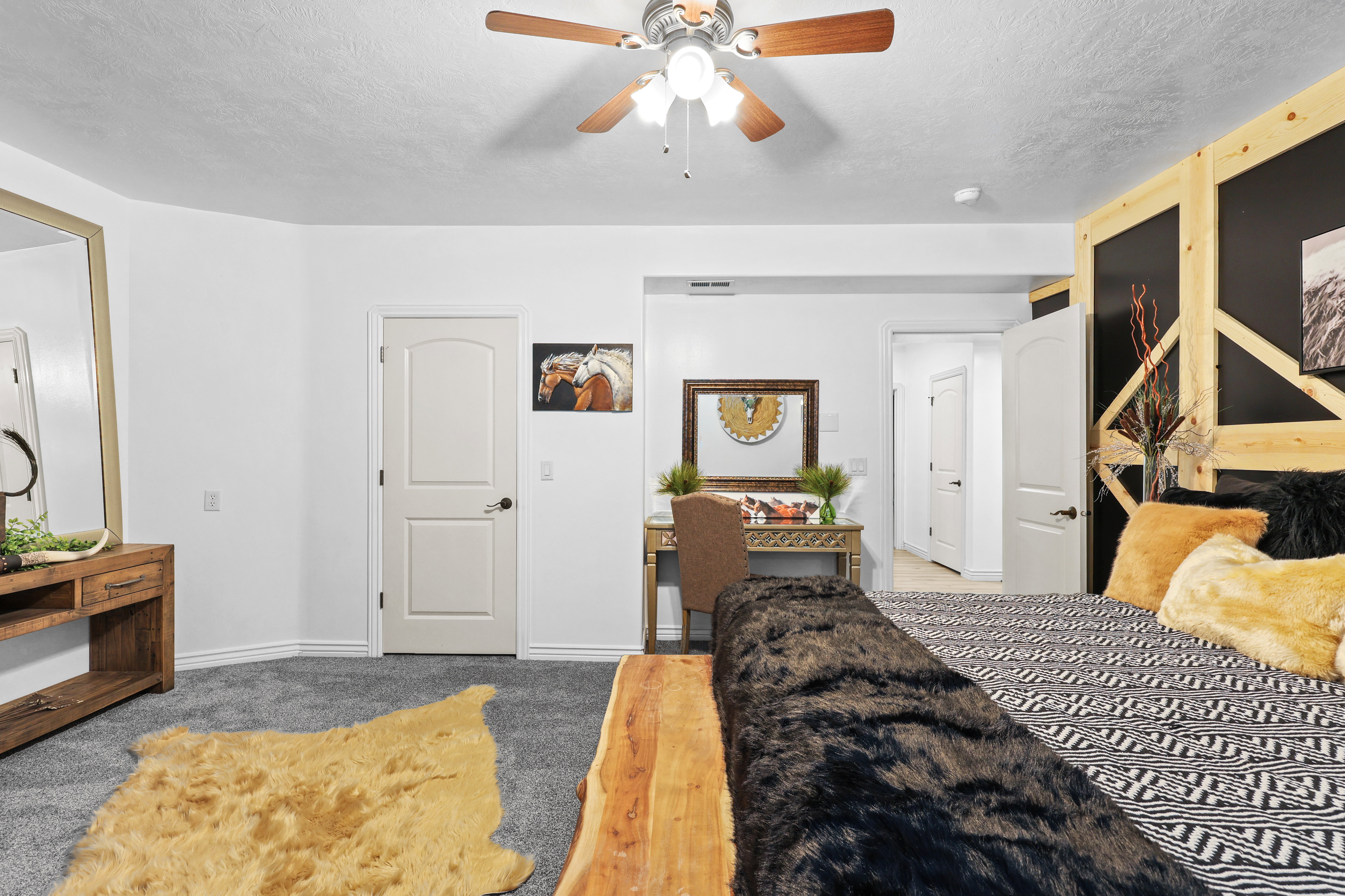 Bedroom featuring light carpet, a textured ceiling, and a ceiling fan