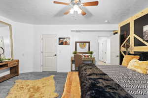 Bedroom featuring light carpet, a textured ceiling, and a ceiling fan