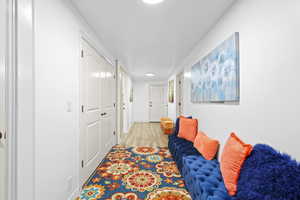 Hallway featuring light wood-style flooring