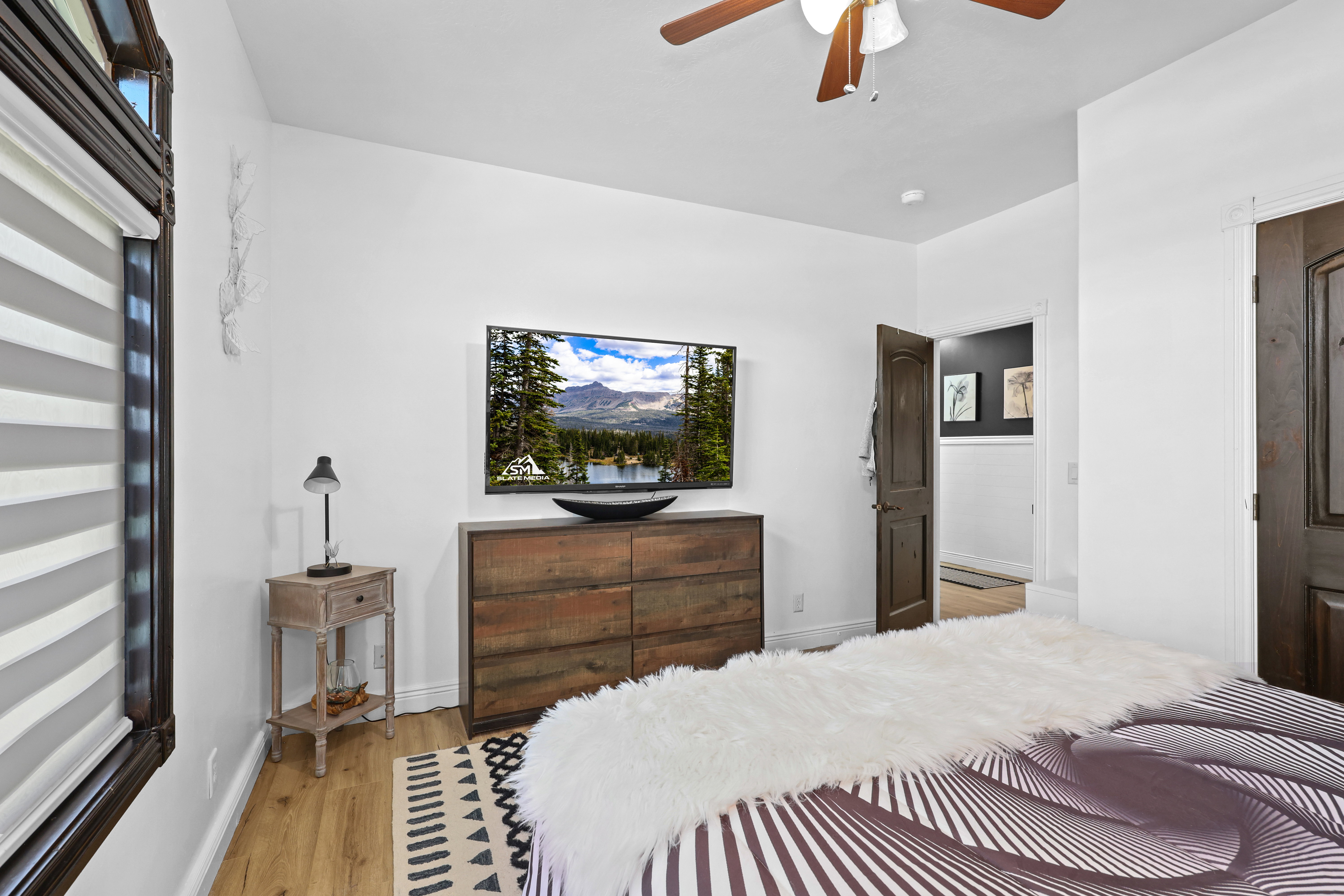 Bedroom with light wood-type flooring and a ceiling fan