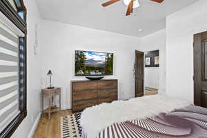 Bedroom with light wood-type flooring and a ceiling fan
