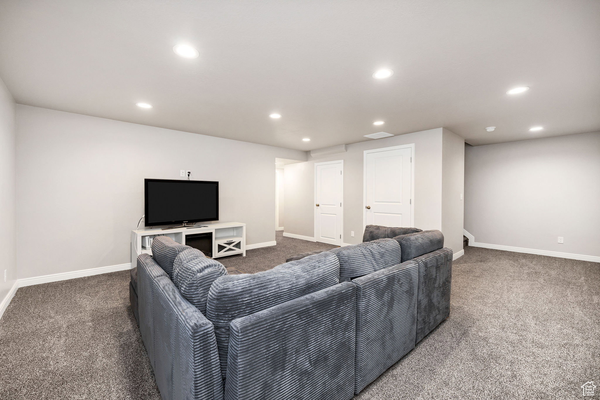 Living area featuring recessed lighting and carpet flooring