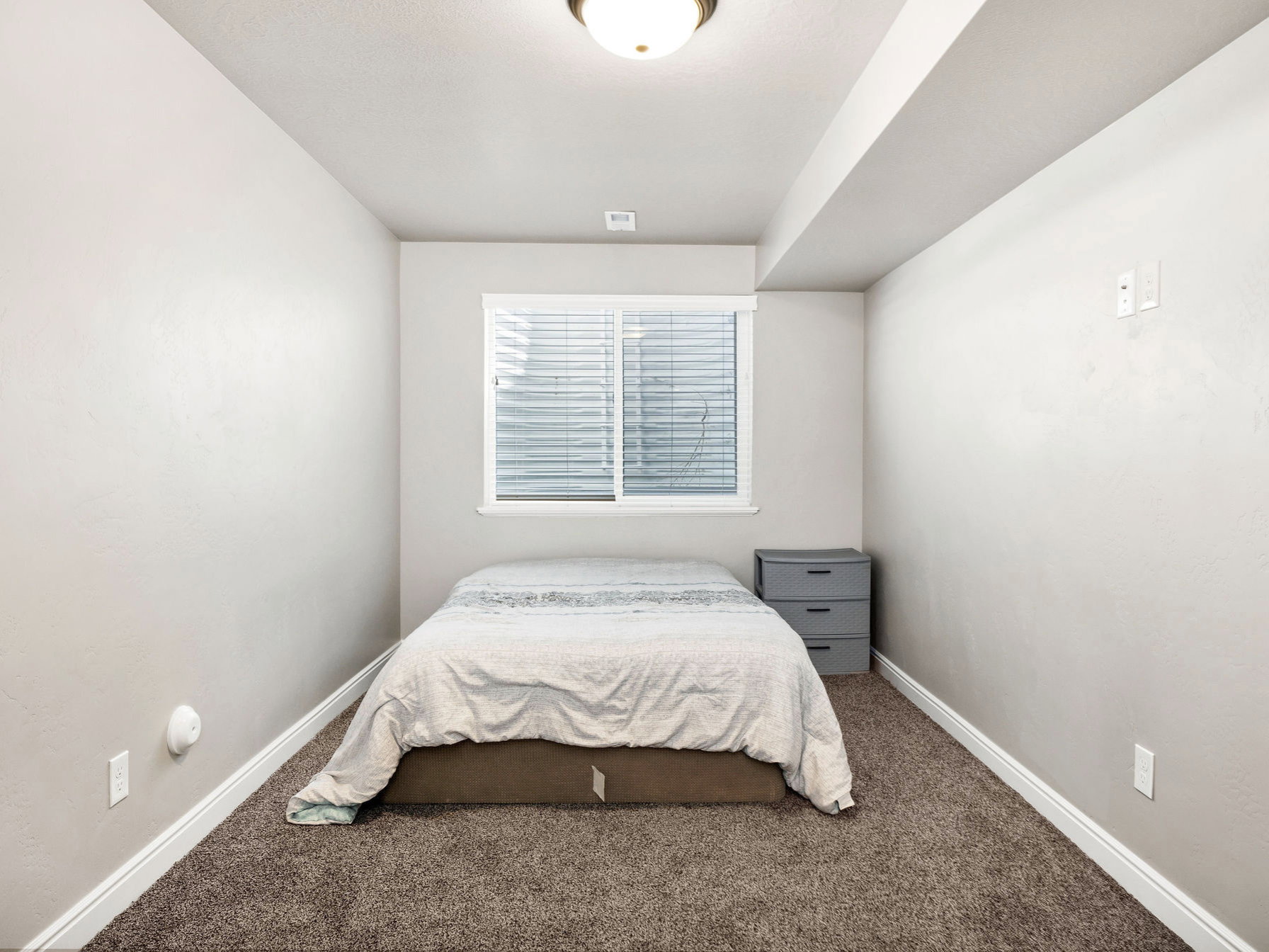 Carpeted bedroom with baseboards