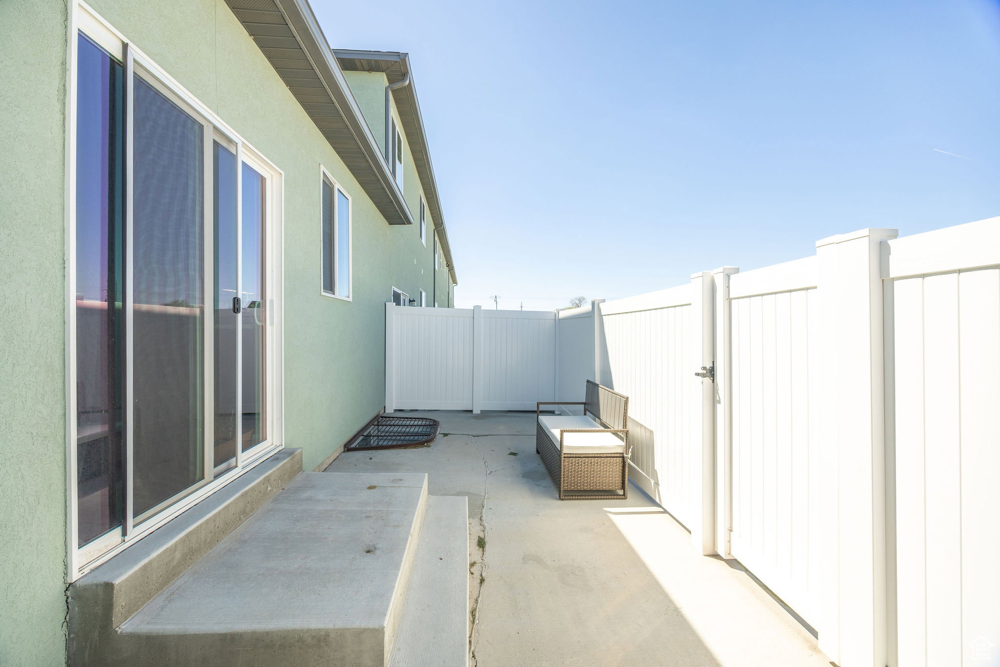 Fenced backyard featuring a gate