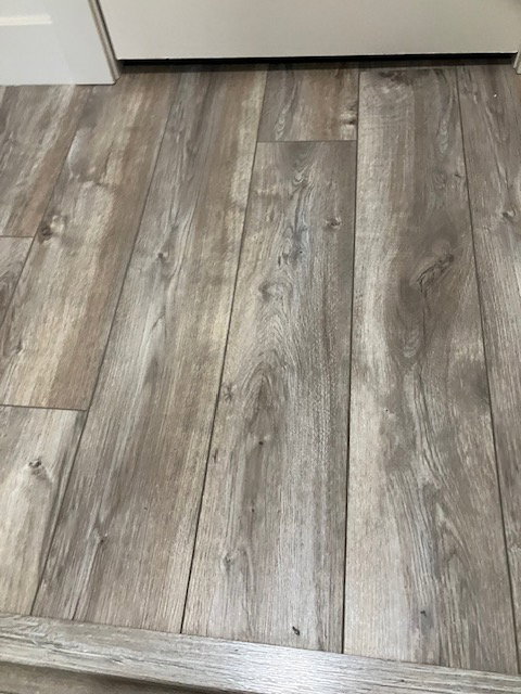 Wood-finish flooring featuring a varied gray and brown grain pattern