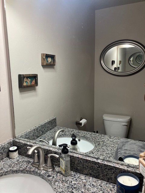 Double vanity featuring granite countertops with undermount sinks and brushed nickel fixtures