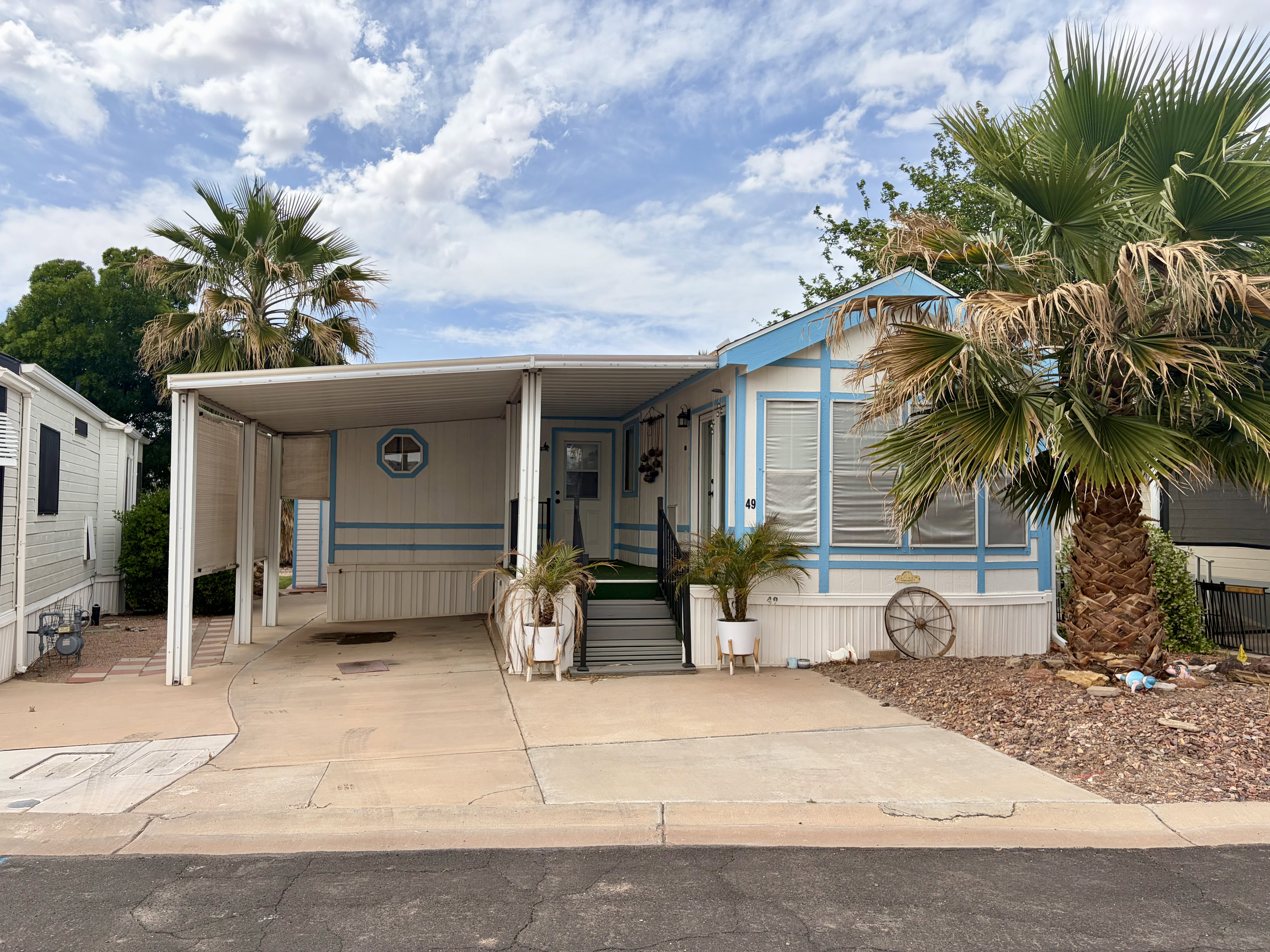 Manufactured / mobile home featuring an attached carport and concrete driveway