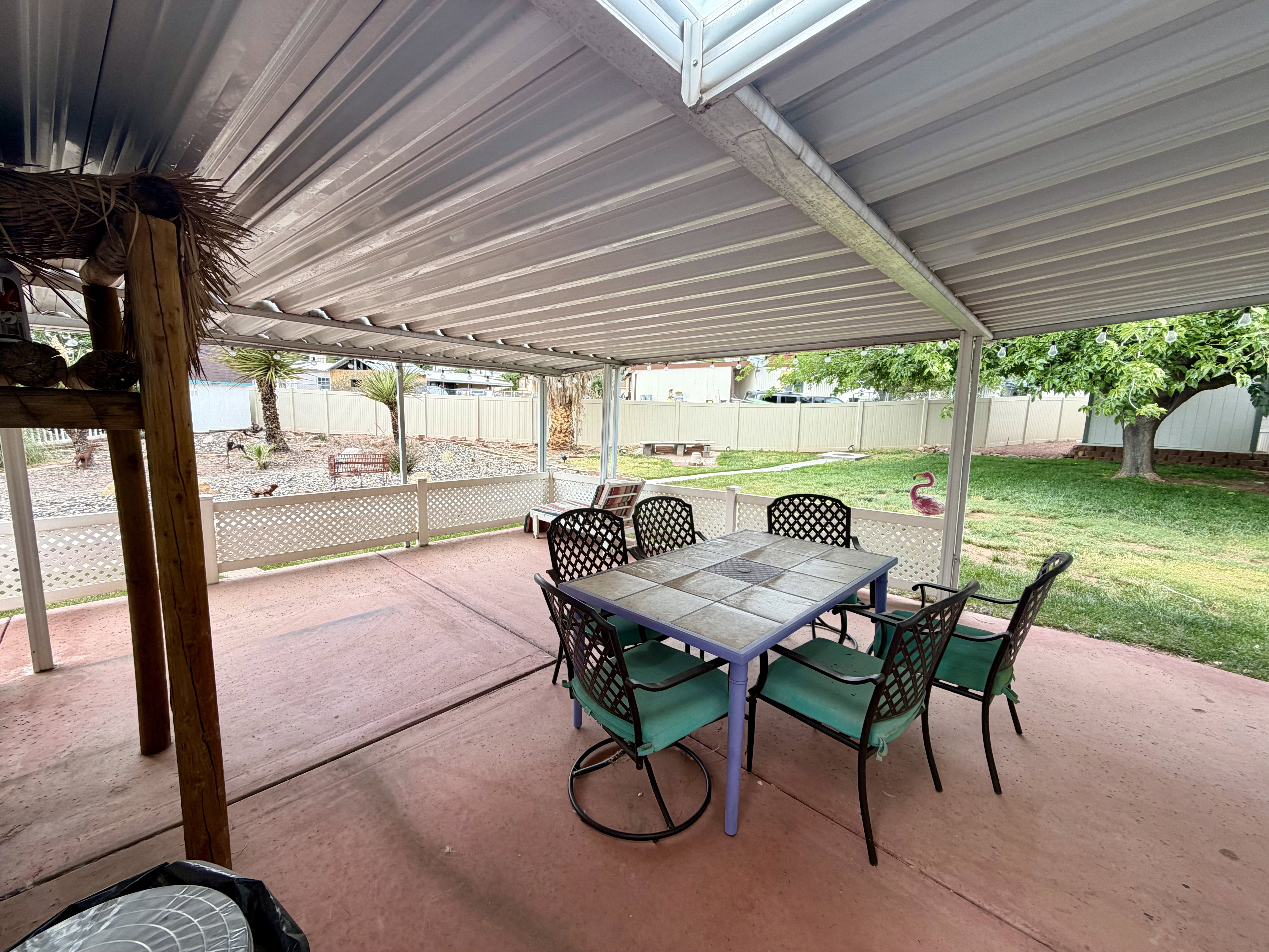 Fenced backyard with outdoor dining area and a patio area