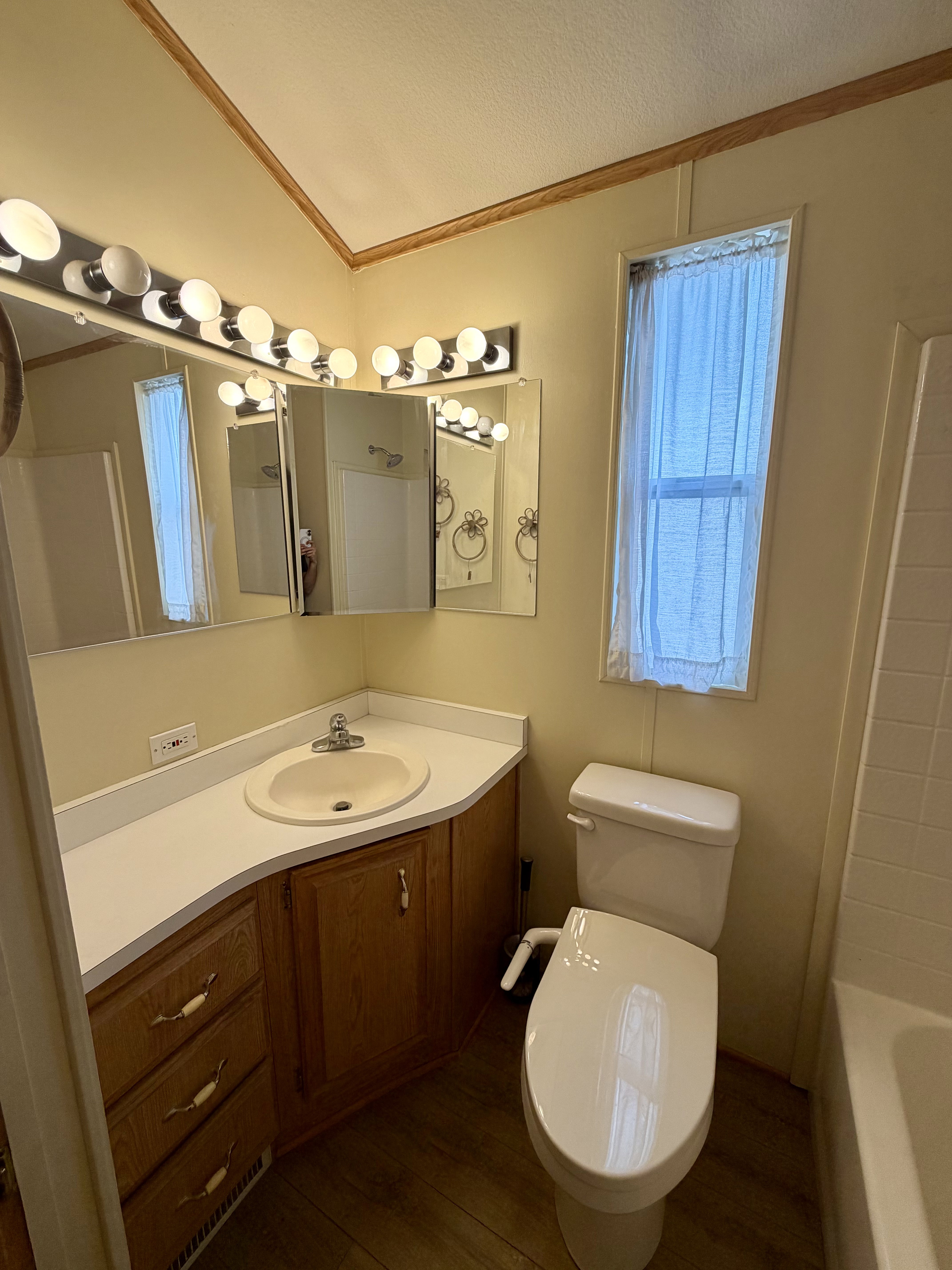 Full bath with crown molding, vanity, dark wood-style flooring, and tub / shower combination