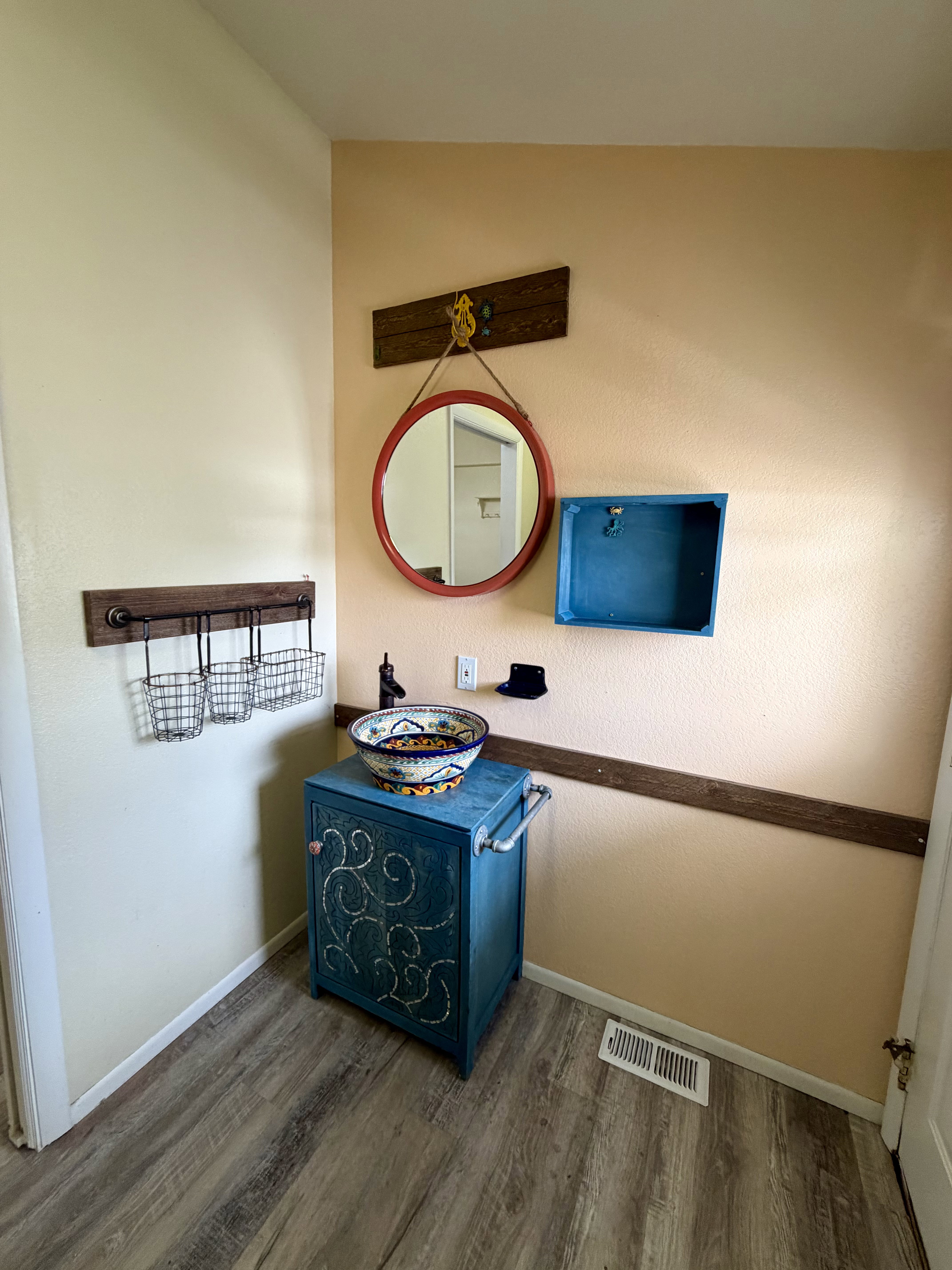 Bathroom with dark wood-type flooring and a sink
