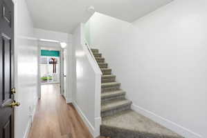 Stairs featuring baseboards and wood finished floors