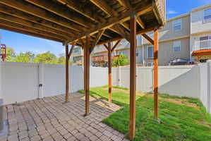 Fenced backyard with a patio