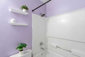 Full bathroom featuring toilet and tub / shower combination