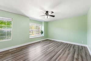 Empty room with light wood-style flooring and a ceiling fan
