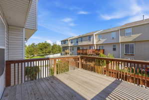 Wooden terrace featuring a residential view