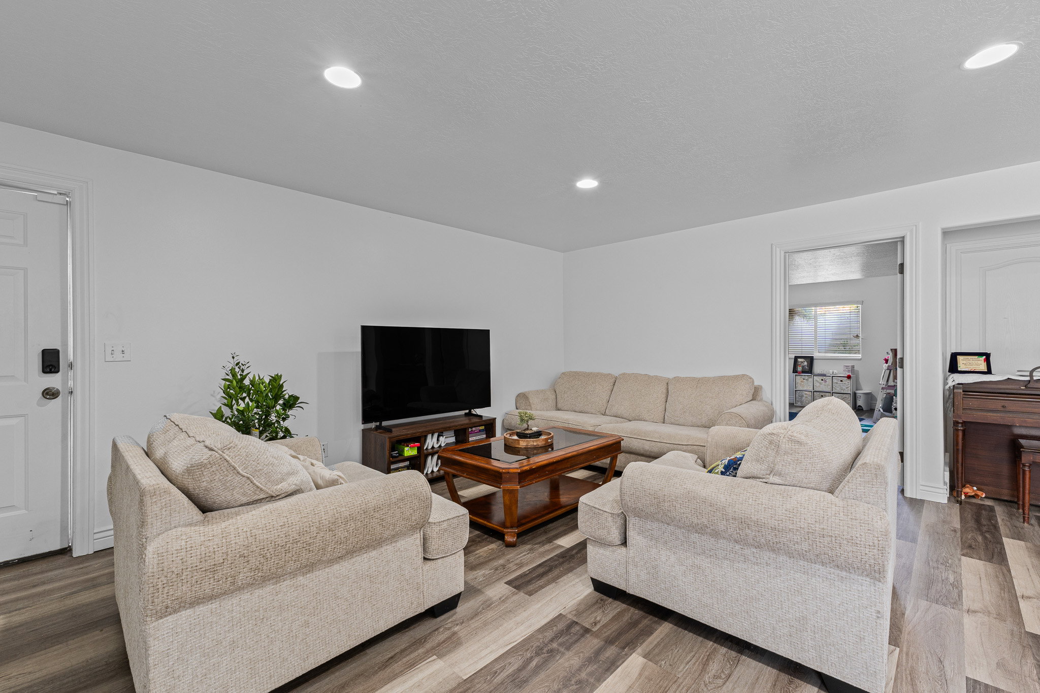 Living area featuring wood finished floors and recessed lighting