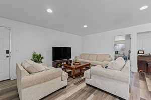 Living area featuring wood finished floors and recessed lighting