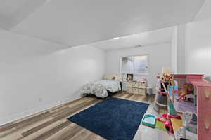 Bedroom with light wood-style flooring and baseboards