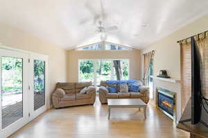 Living area featuring ceiling fan, healthy amount of natural light, and light wood-style flooring