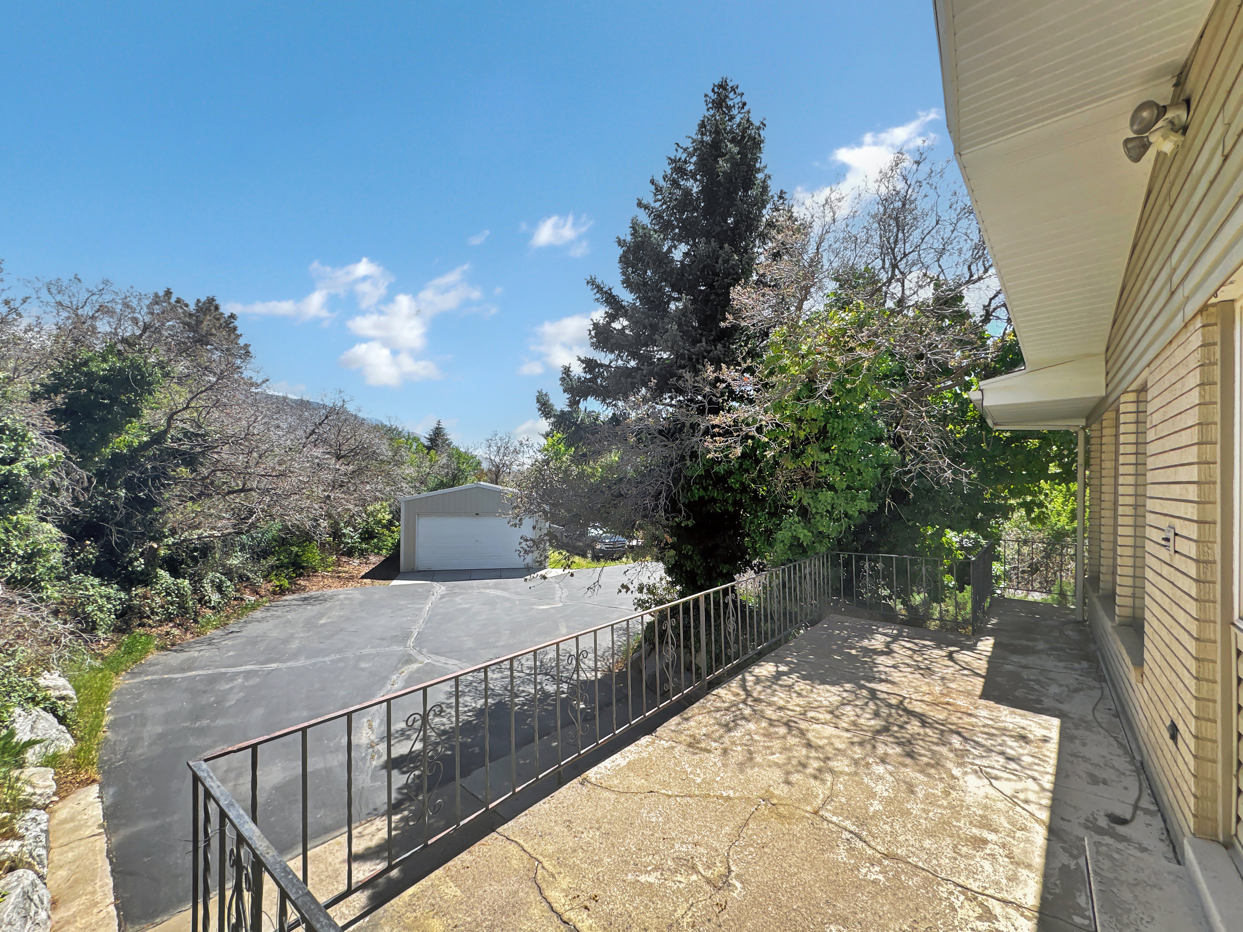View of patio / terrace featuring a garage and an outdoor structure