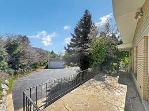 View of patio / terrace featuring a garage and an outdoor structure