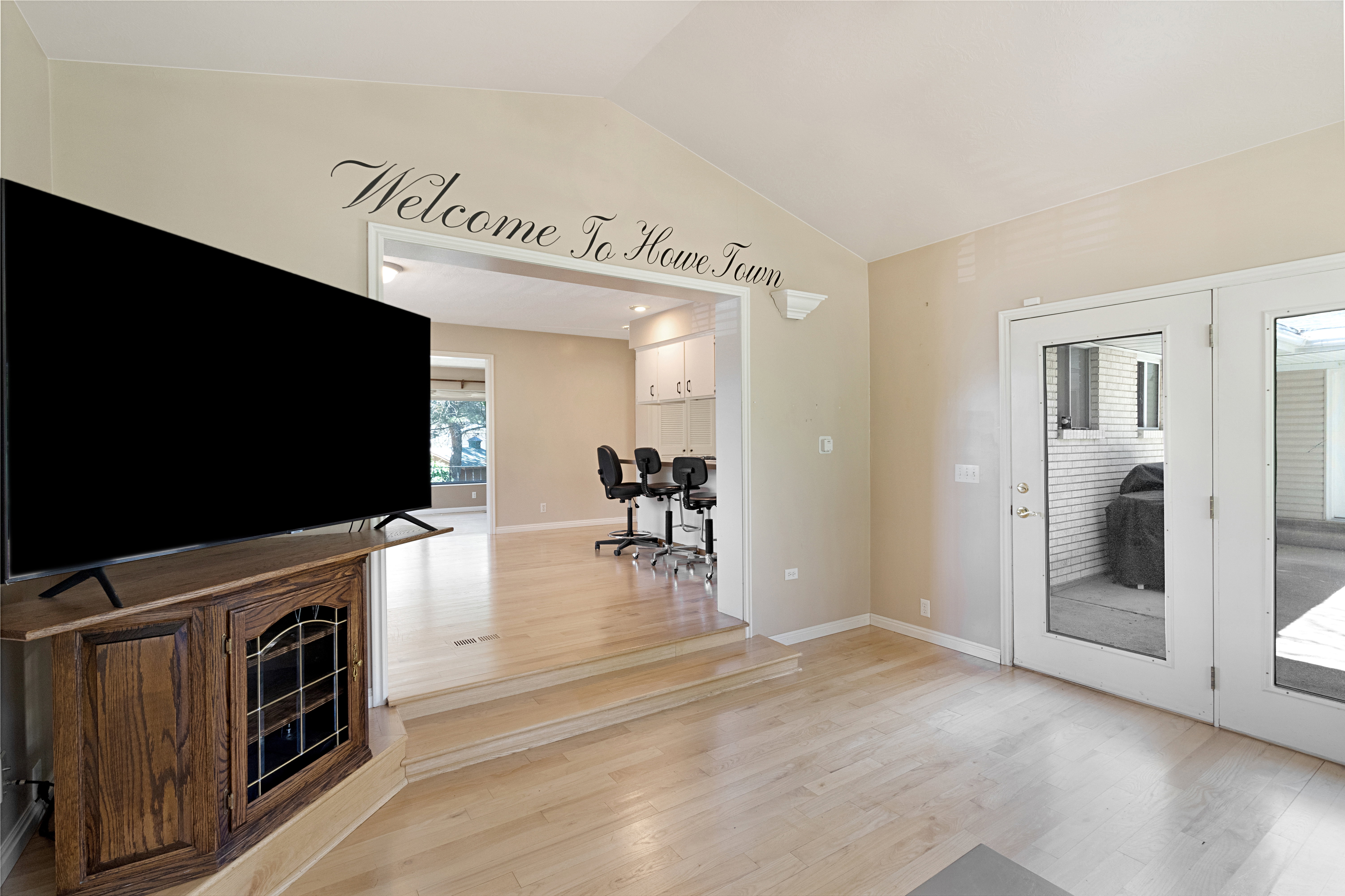 Unfurnished living room with light wood-style flooring and an office area