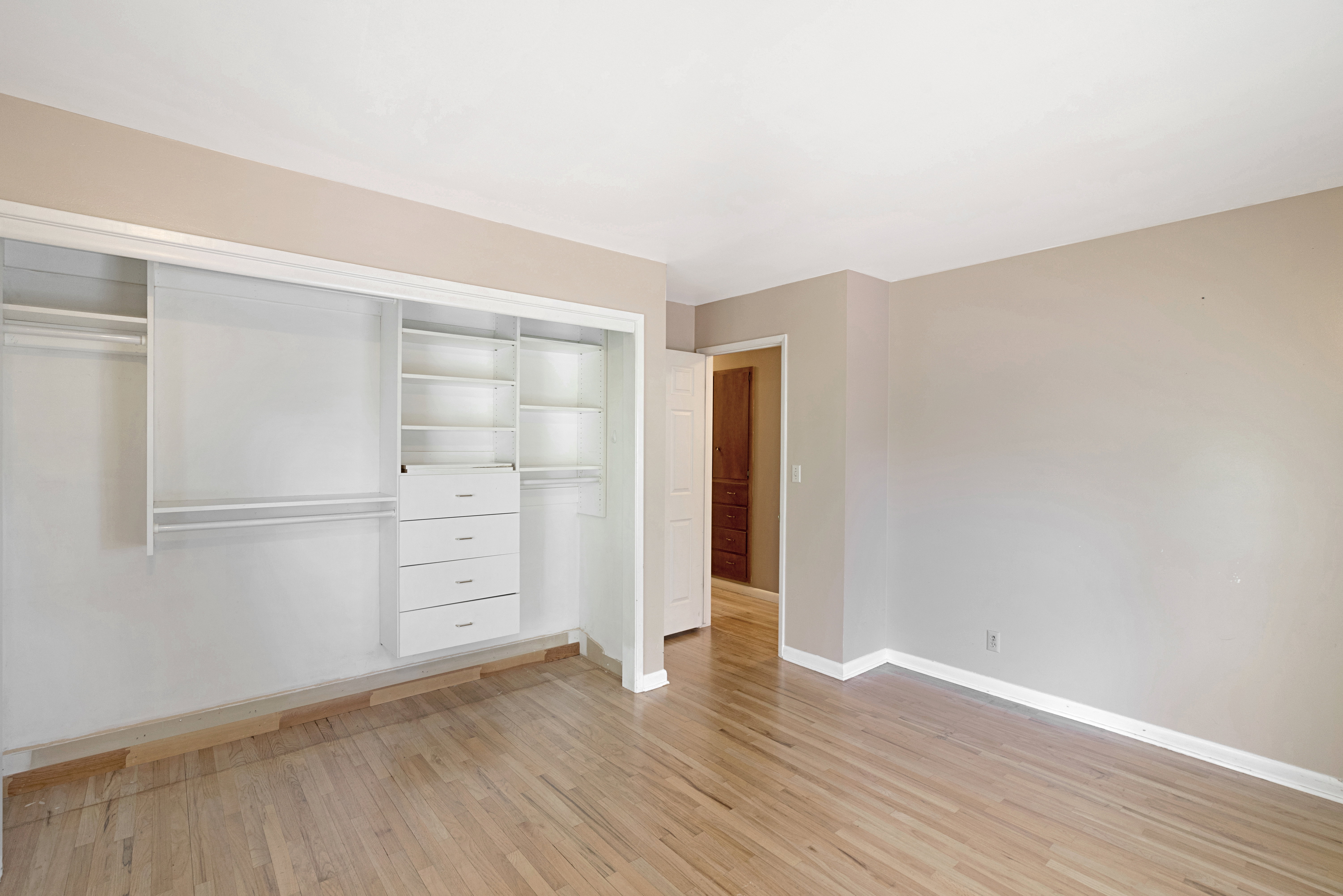 Unfurnished bedroom with light wood finished floors and a closet