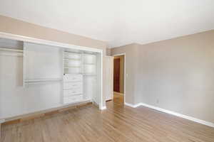 Unfurnished bedroom with light wood finished floors and a closet