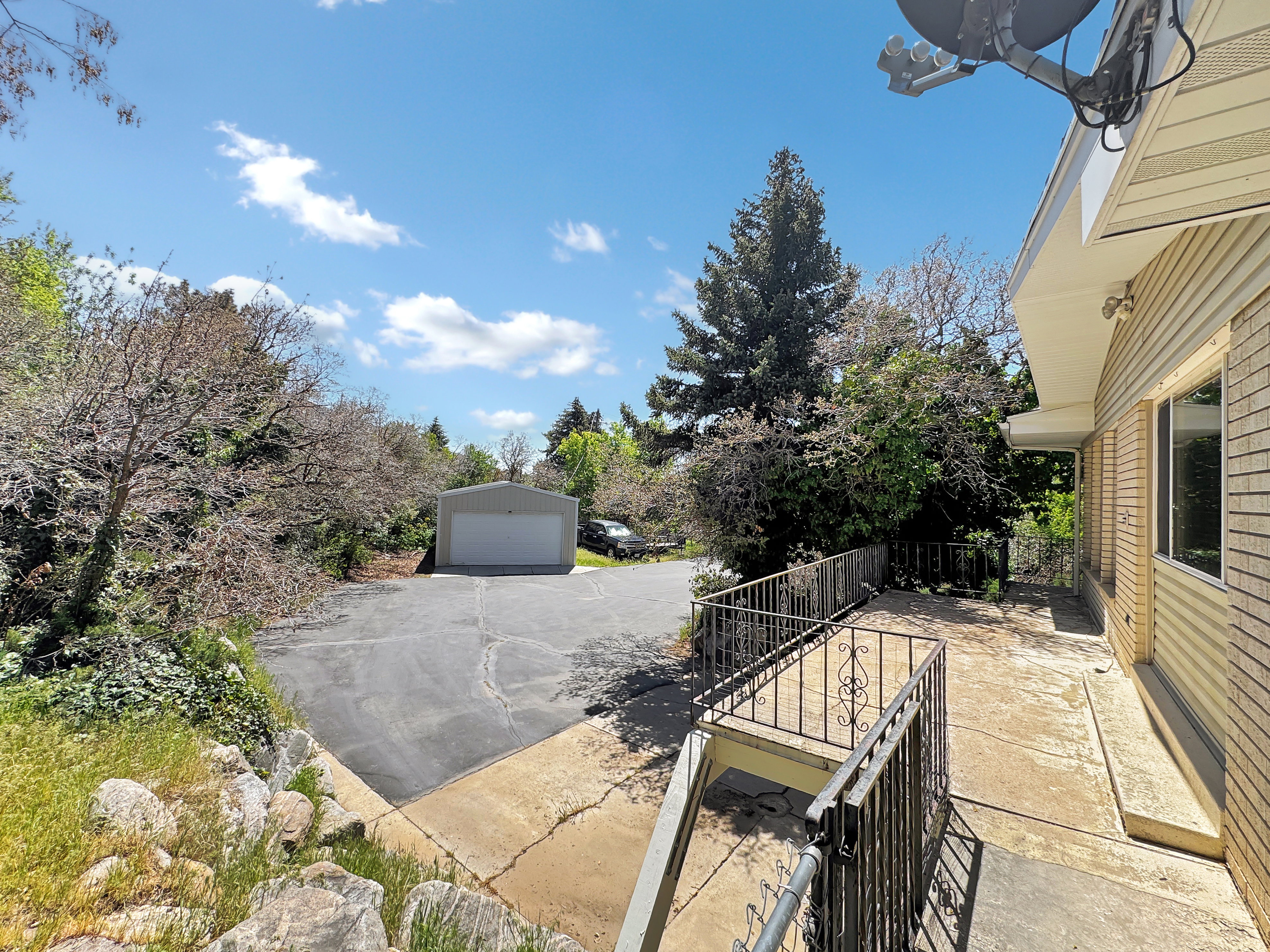 View of patio with a garage and an outdoor structure