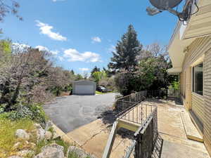 View of patio with a garage and an outdoor structure
