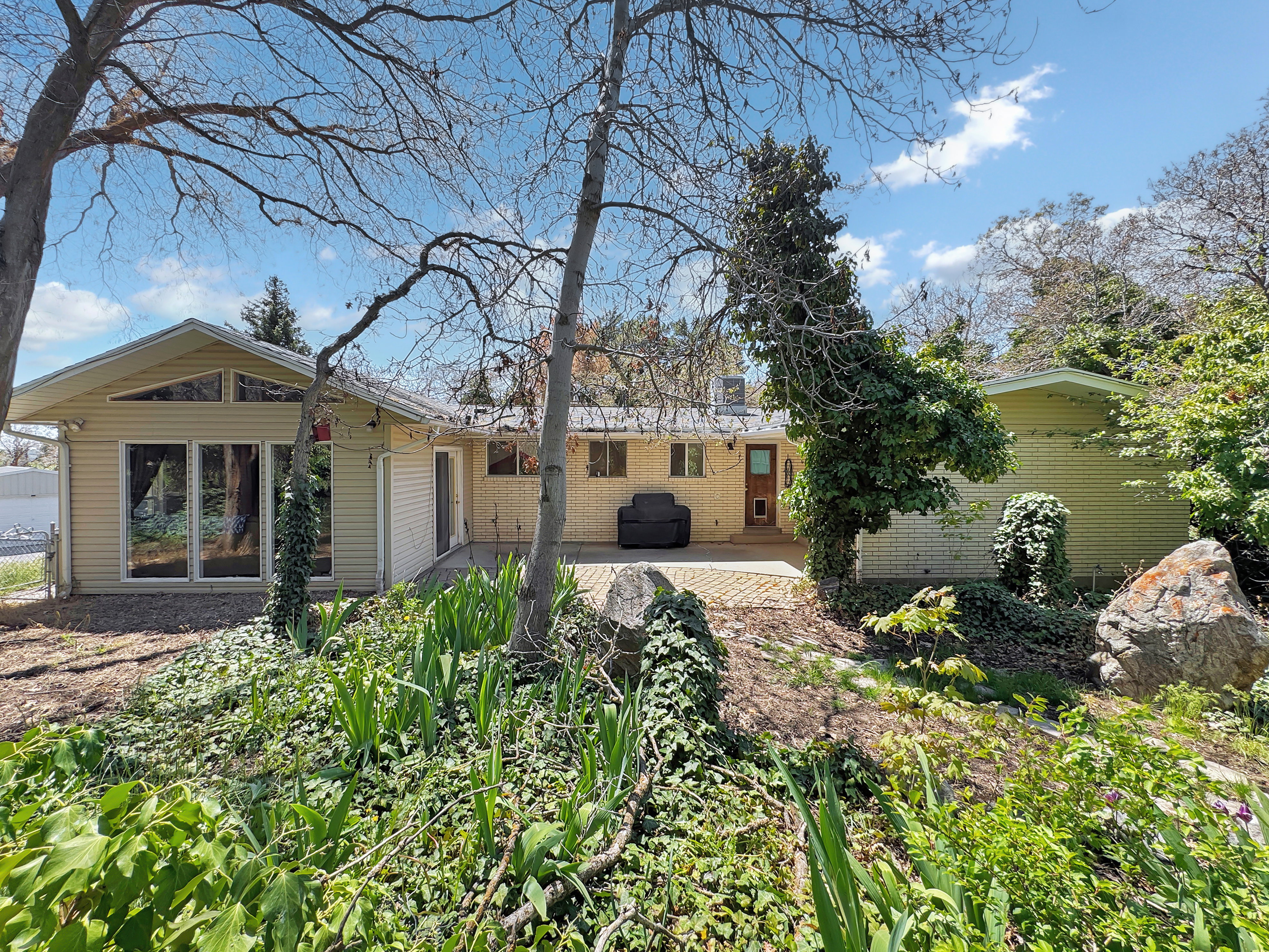 Rear view of property featuring a patio and brick siding