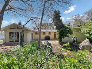 Rear view of property featuring a patio and brick siding