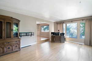 Living area featuring light wood finished floors and baseboards