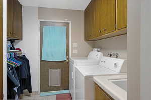 Laundry room with separate washer and dryer and cabinet space