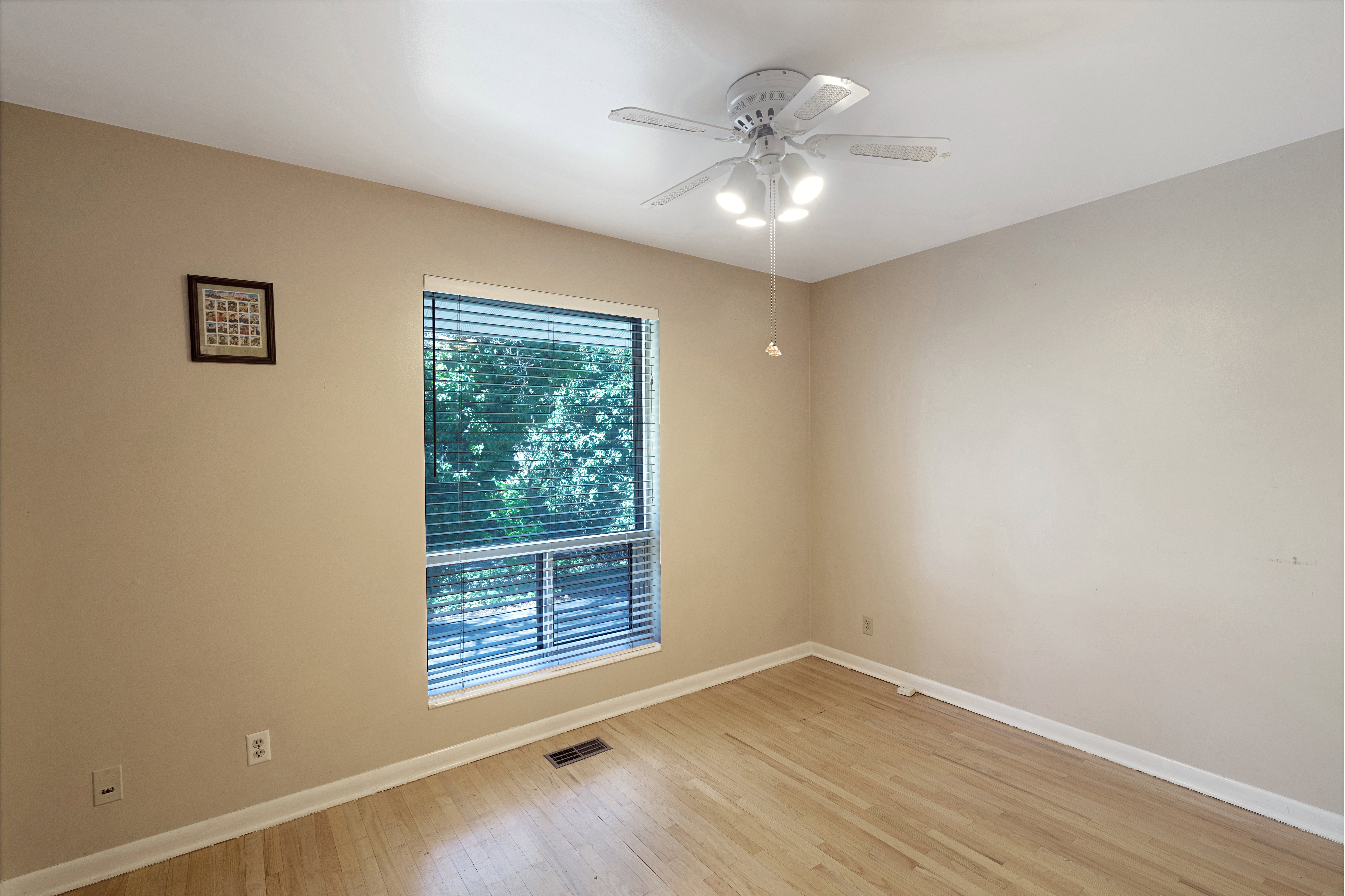 Spare room with a ceiling fan and light wood-style floors