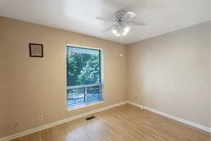 Spare room with a ceiling fan and light wood-style floors