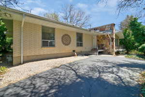 View of front facade featuring brick siding and asphalt driveway