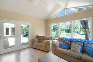 Living area featuring a ceiling fan and light wood-type flooring