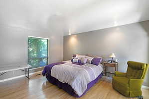 Bedroom with light wood-style flooring and baseboards