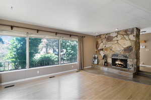 Unfurnished living room with light wood-style flooring and a fireplace