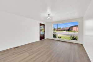 Empty room featuring light wood-style flooring and a textured ceiling