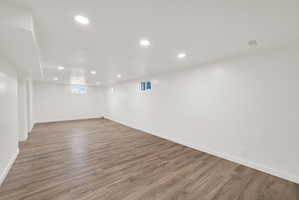 Basement featuring recessed lighting and dark wood-style floors