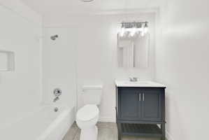 Bathroom featuring vanity, shower / bath combination, and light tile patterned floors