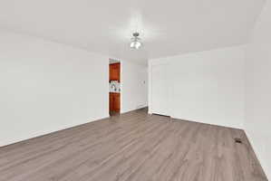 Unfurnished room with light wood-style flooring and baseboards