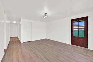 Unfurnished room with light wood finished floors and baseboards