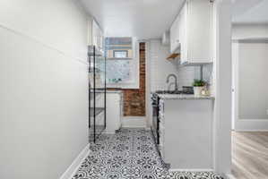 Updated with tile and original brick accent wall
