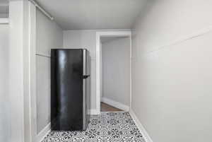 Refrigerator, a table will fit in this area and the refrigerator can be moved next to the counter, across from the range