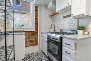 Updated kitchen with range, the refrigerator originally was placed where the shelving is